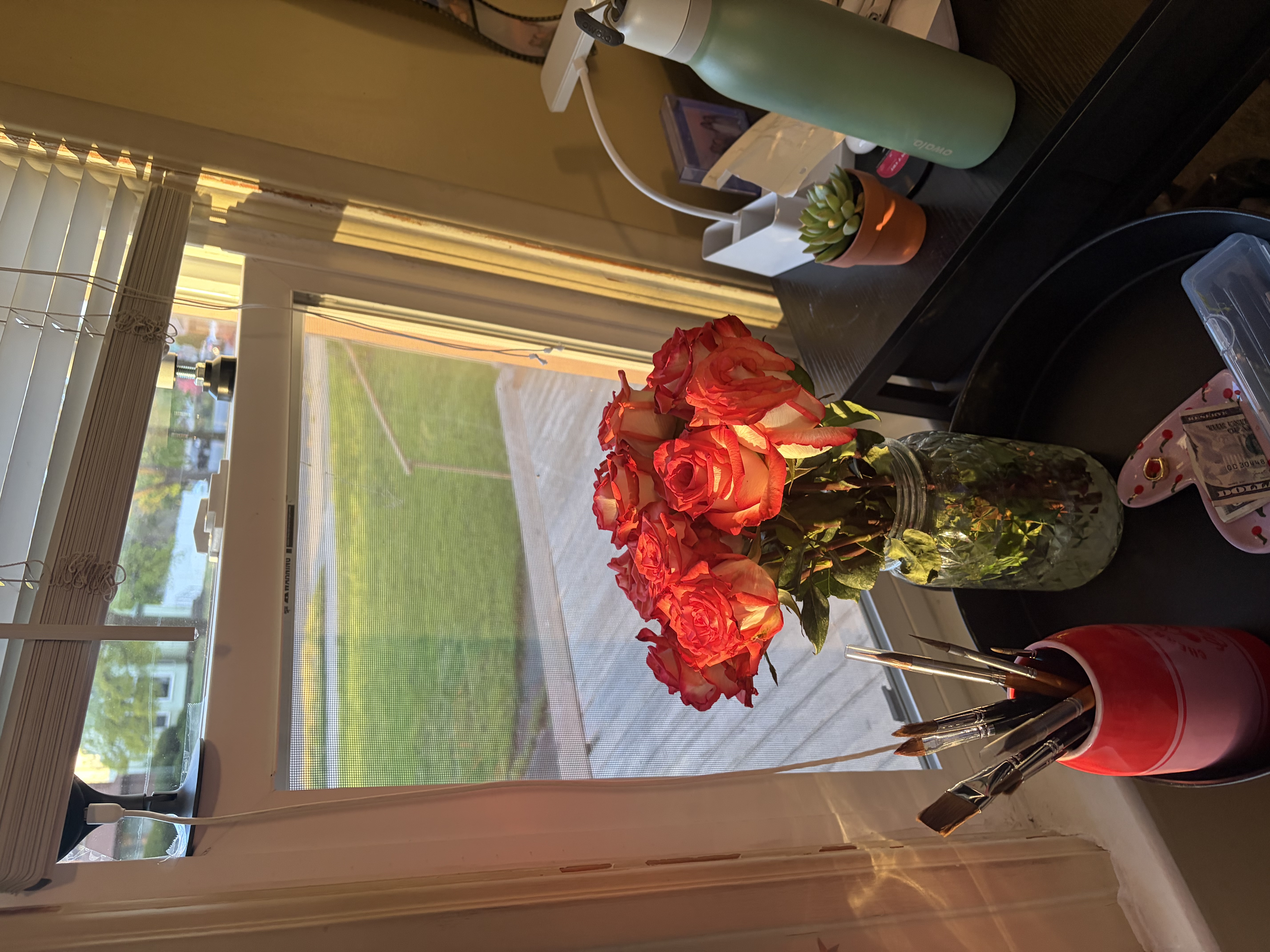 Orange roses in a studio workspace